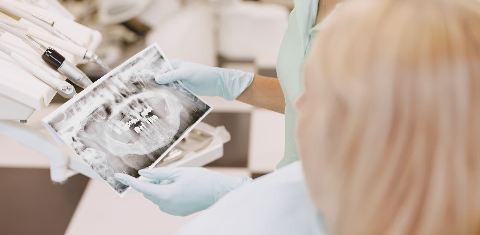 Dentist reviewing dental X-ray in clinical setting